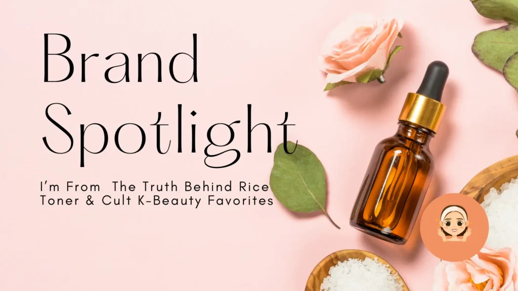 An aesthetic skincare banner for a "Brand Spotlight" feature. The headline is written in an elegant, thin serif font against a soft pastel pink background. Subtext reads: "I’m From – The Truth Behind Rice Toner & Cult K-Beauty Favorites." The visual composition includes a brown glass apothecary dropper bottle surrounded by delicate pink roses, green eucalyptus leaves, and small wooden bowls filled with white rice grains, creating a natural and clean K-beauty vibe. A small orange icon of a person with a headband is in the bottom right corner.